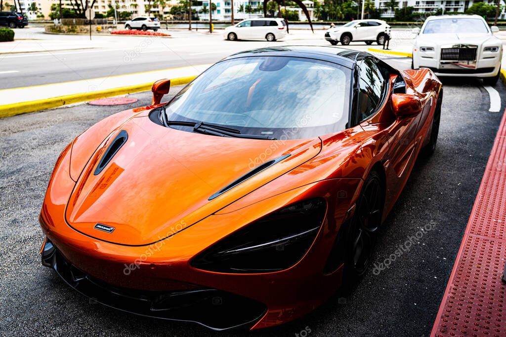Miami, Florida, USA - JUNE 2020: Autumn fashion. Orange car. Exclusively to exotic sports cars and hypercars. McLaren is now in the business of building high-performance road cars