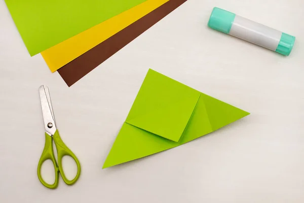 Step-by-step instructions for making Christmas Tree Corner Bookmarks. DIY. Creative origami ideas for kids. Top view flat lay. Step 3 — Stock Photo, Image
