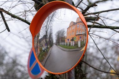 Autumn. Reflection of a city street in an outdoor convex mirror. clipart