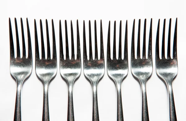 Cutlery, forks, knives, dispenser for salt and pepper, spoons, glasses, wine glasses, saucers, sugar dispenser