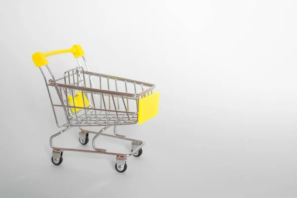 Grocery Cart Yellow Handle Gray Background Side View Horizontal Format — Stock Photo, Image