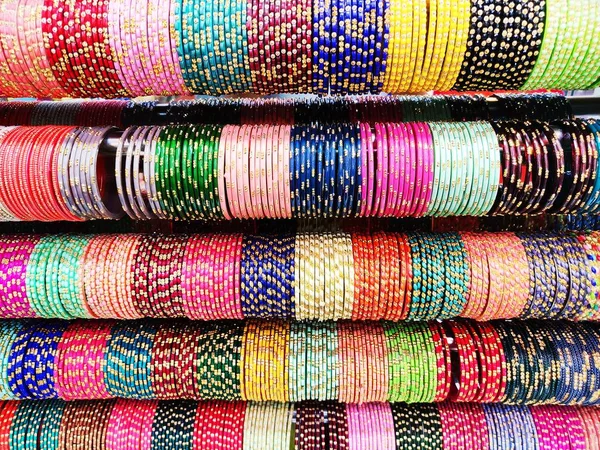 Bangles and bracelet colourful arranged in row for sale in indian , these jewellery worn in hand by Indian woman on festival