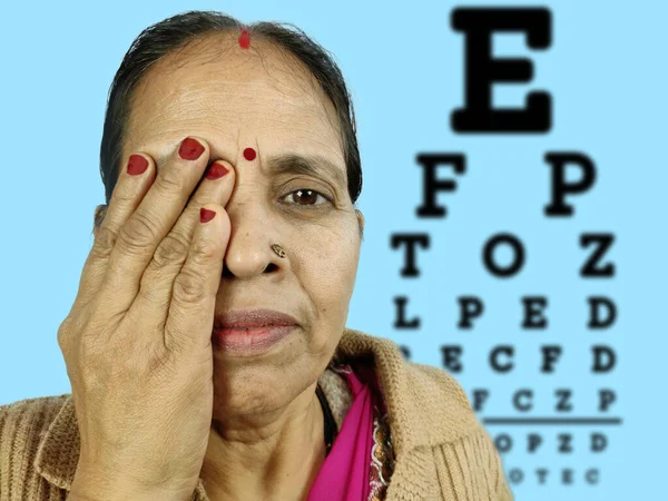 An eye close or hide due to testing at eye clinic , indian woman — Stock Photo, Image