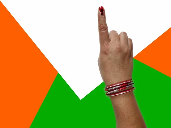 Voting ink on finger of woman on indian flag showing election voter and Indian democracy polling by woman.