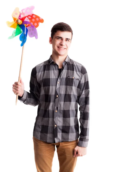 Colour windmill in hands of young man isolated — Stock Photo, Image