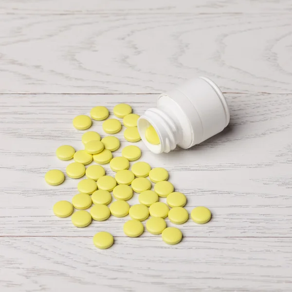 Yellow pills with bottle — Stock Photo, Image