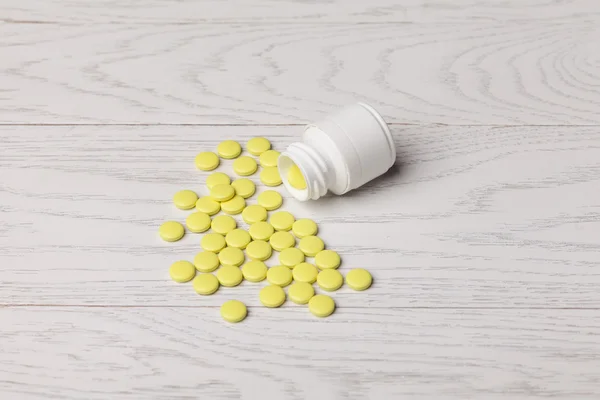 Yellow pills with bottle — Stock Photo, Image