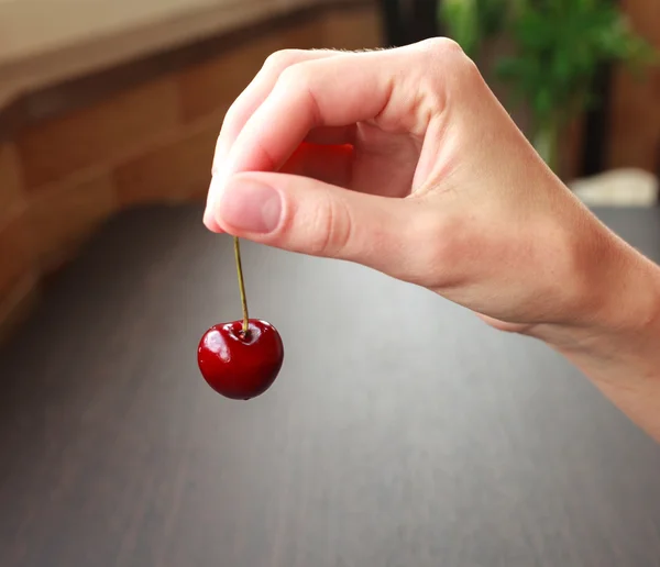 Fresh cherry in woman hand — Stock Photo, Image