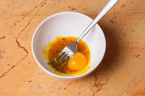 Woman mixing eggs in white bowl — Stock Photo, Image