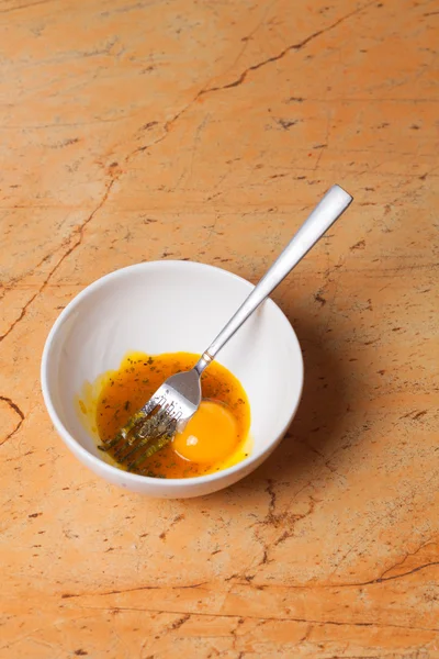 Woman mixing eggs in white bowl — Stock Photo, Image