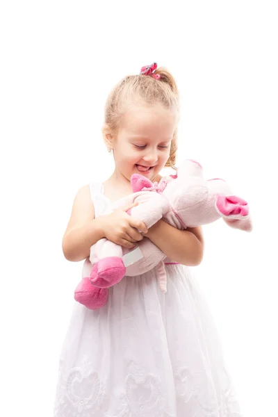 Cute little girl hold toy pig isolated — Stock Photo, Image