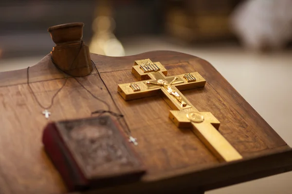 Gouden christelijke kruis op tafel — Stockfoto