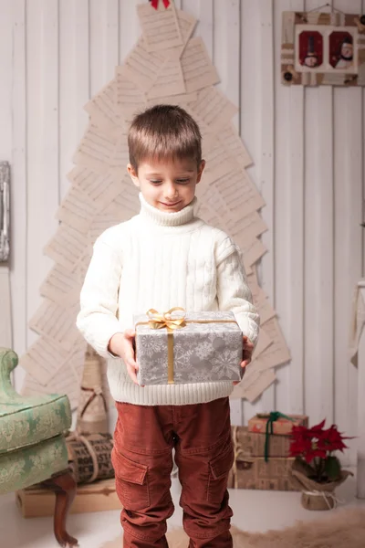 Little boy hold present in Christmas interior — Stock Photo, Image