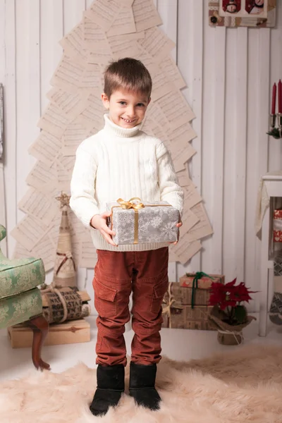 Little boy hold present in Christmas interior — Stock Photo, Image