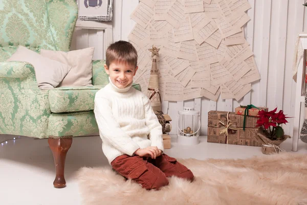 Little boy on carpet in Christmas interior — Stock Photo, Image