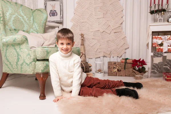 Little boy on carpet in Christmas interior — Stock Photo, Image