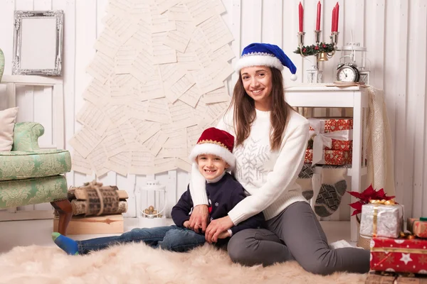 Little boy with mom posing in Christmas interior — Stock Photo, Image