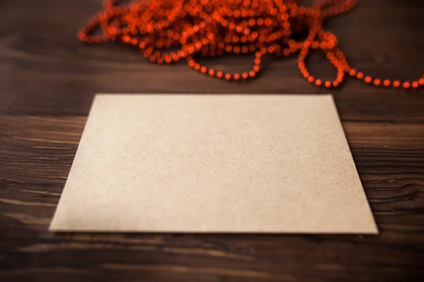 Envelope with Christmas decoration on wood table — Stock Photo, Image