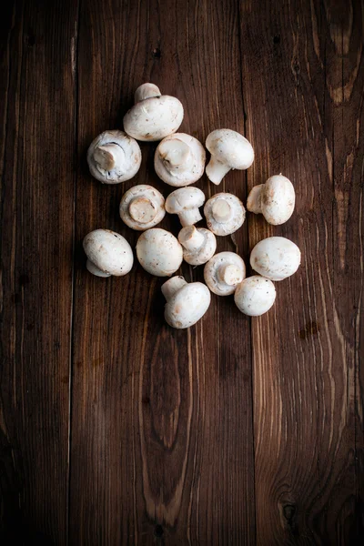 White mushrooms on wood table — Stock Photo, Image