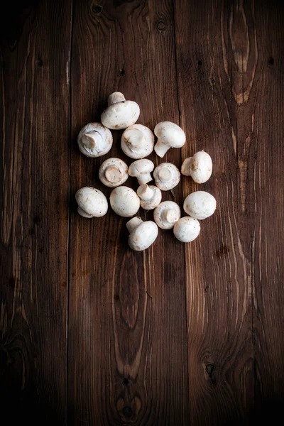 White mushrooms on wood table — Stock Photo, Image