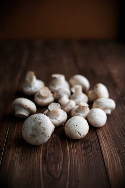 White mushrooms on wood table — Stock Photo, Image