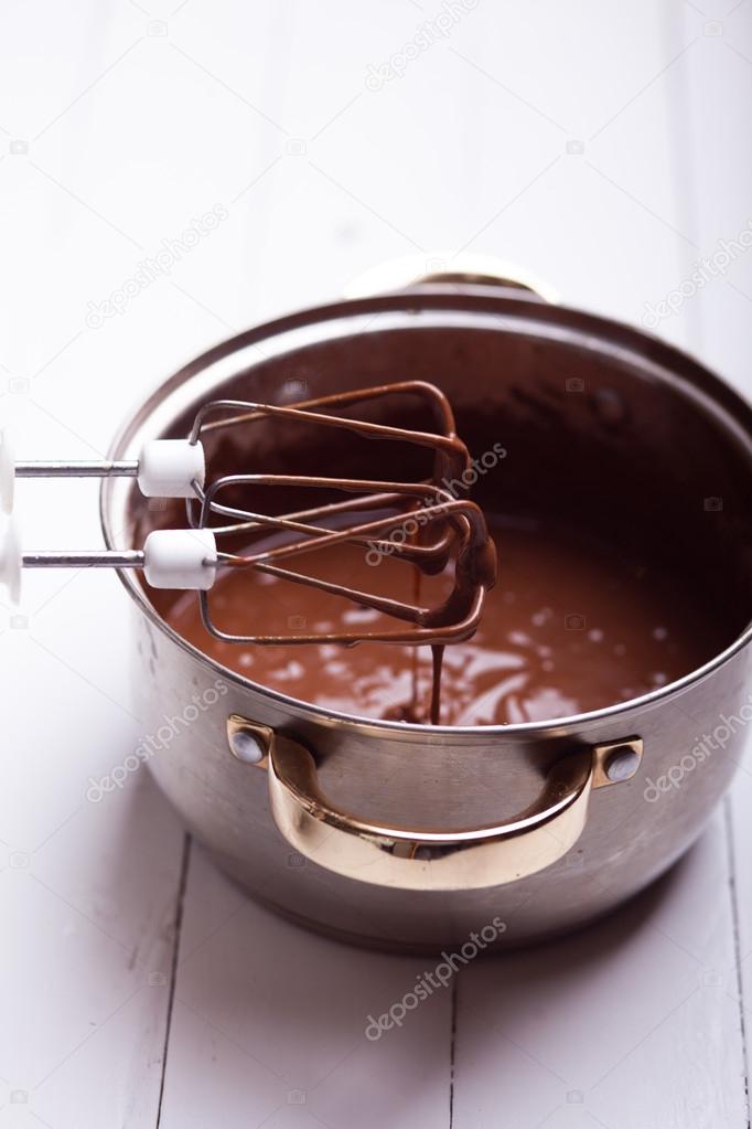 Chocolate syrup leaking from kitchen tool on table