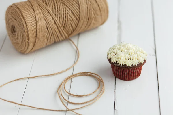 Chocolate cupcake with butter cream on wooden table — Stock Photo, Image