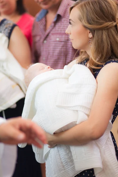 Little girl on mother hands in church — Stock Photo, Image