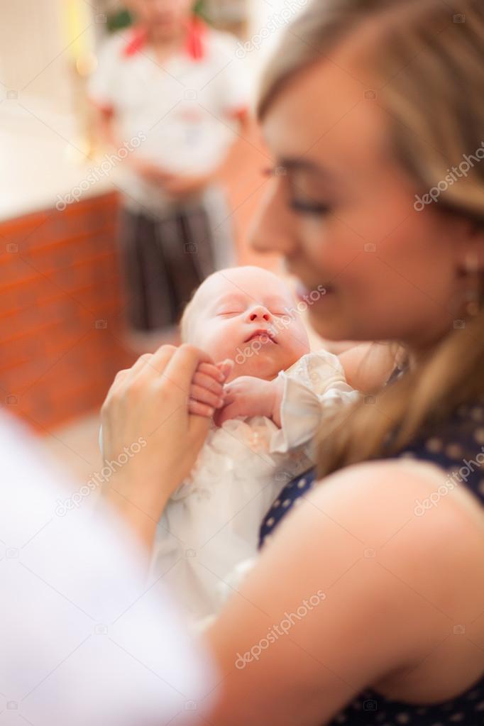 Little girl on ceremony of child christening