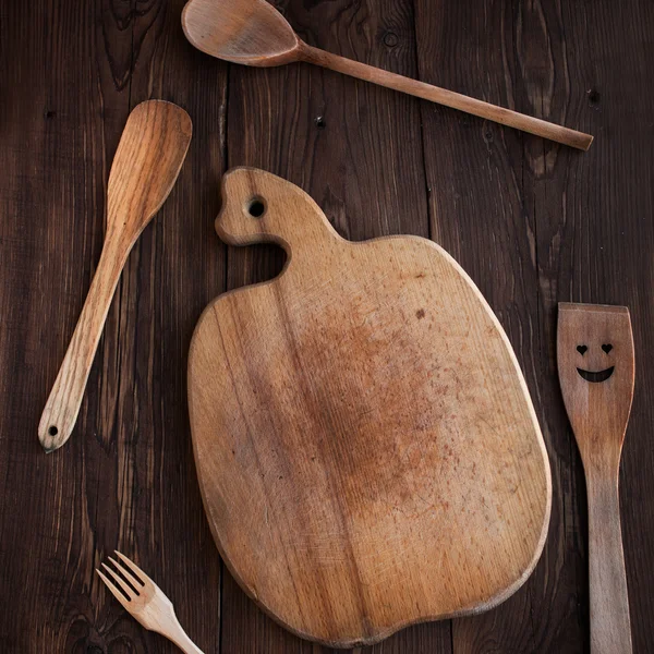 Kitchen board with wood tools on wood table,square — Stock Photo, Image