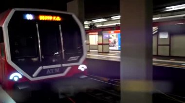 İçinde maske takan birkaç kişi olan kırmızı metro treni metro istasyonuna varıyor. Yeraltı treni platforma varıyor. Avrupa modern toplu taşımacılığı. Kapalı, yeni normal, tecrit. 