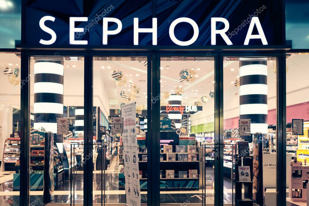 Milan, Italy - 17.12.2020. Sephora logo and showcase of the store at night with christmas decoration. Sephora is makeup, perfume, beauty cosmetics store.