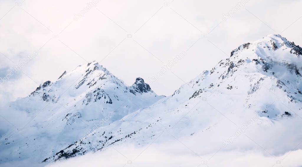 Panoramic view of mountains near Brianson, Serre Chevalier resort, France. Foggy winter mountain landscape. Ski resort landscape. Winter vacation. Misty morning in mountains