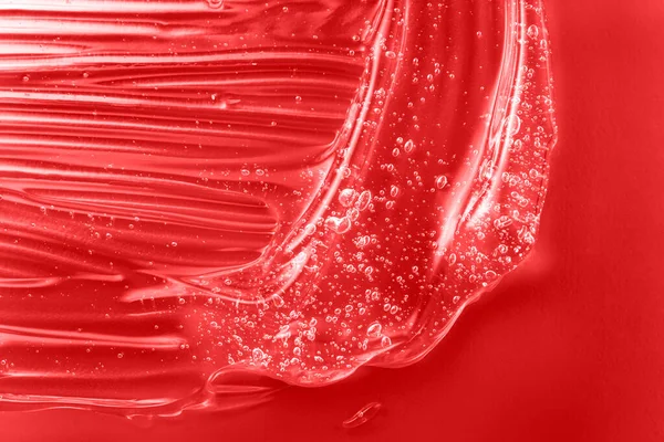 Textura de gel con burbujas. Mancha de mancha de crema hidratante roja. Producto cosmético limpiador de gelatina. Cosmética líquida en suero, crema con muestra de colágeno. Tóner ácido hialurónico con muestra de retinol. — Foto de Stock