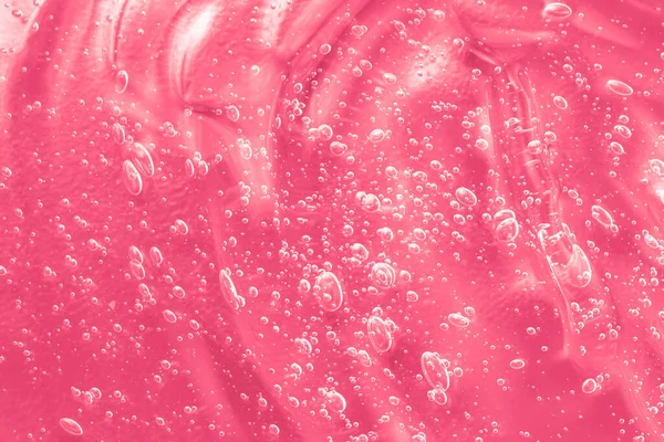 Roze moisturizer smeren vlek textuur. Jelly cleanser cosmetisch product. Gel serum vloeibare cosmetica, crème met collageen monster. Hyaluronzuurtoner met retinol en ceramidestaal — Stockfoto