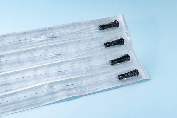 Rusch male and female all purpose catheter on blue background, straight tipped intermittent catheters designed for a single use, packaged individually and sterile