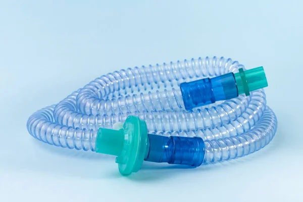 Tubulação para CPAP ou máquina BIPAP com filtro verde isolado em fundo azul. — Fotografia de Stock