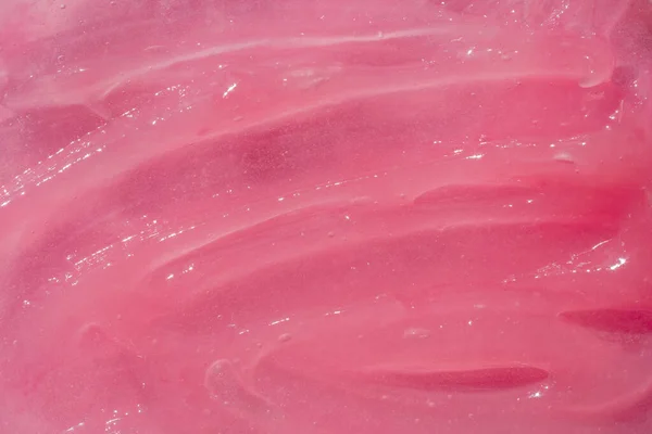 Crema cosmetica, balsamo sbavatura macchia campione, rosa rosa texture sfondo. Texture del prodotto cosmetico. Goccia idratante, maschera, fondale di burro di karitè, chiazza di pomata. — Foto Stock