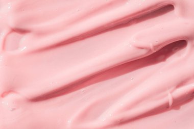 Pink color cosmetic cream lotion moisturizer smear smudge sample. Beauty cream texture background. Skin care product strokes closeup.