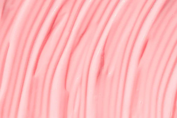 Colore rosa crema cosmetica crema crema idratante texture campione sbavatura. Bellezza crema texture sfondo. Colpi di prodotto per la cura della pelle primo piano. Cremoso sfondo strutturato. — Foto Stock