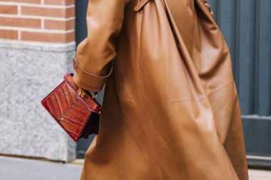 Milan, Italy - September, 24, 2025: woman wears white Fendi ISeeU Petite brown bag. Fashion outfit handbag details, street style look accessory
