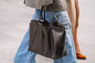 Paris, France - October, 06, 2025: woman wears Tods shopping bag. Fashion outfit handbag details, street style look accessory