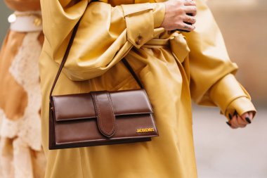 Paris, France - October, 06, 2025: woman wears Jacquemus bambino long flap bag. Fashion outfit handbag details, street style look accessory
