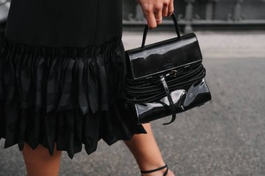 Milan, Italy - September, 25, 2025: woman wears Moschino Tie Me bag. Fashion outfit handbag details, street style look accessory