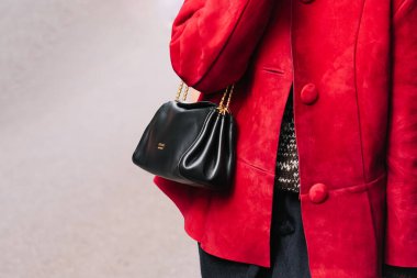 Milan, Italy - September, 25, 2025: woman wears Prada Tumulte nappa leather bag. Fashion outfit handbag details, street style look accessory