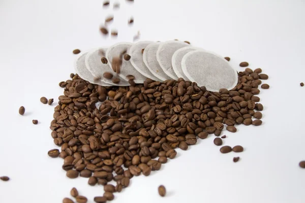 Coffee pods with falling coffee beans — Stock Photo, Image