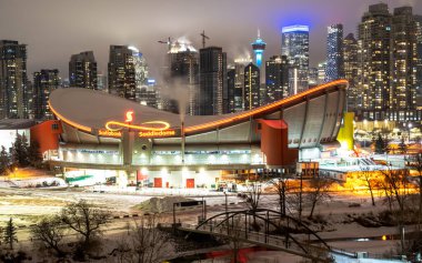 Calgary Alberta Canada, January 26, 2021: The Olympic Saddledome hockey arena home of the Calgary Flames NHL team in the downtown district of a Canadian city. clipart