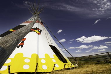 Alberta Alberta Canada, July 30 2021: An indigenous Teepee set up at Head Smashed in Buffalo Jump world heritage site under a blue summer sky.