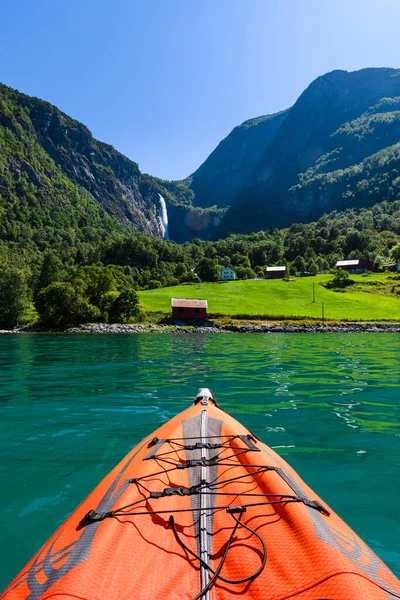 Red Inflatable kayak in front of Norwegian scenery