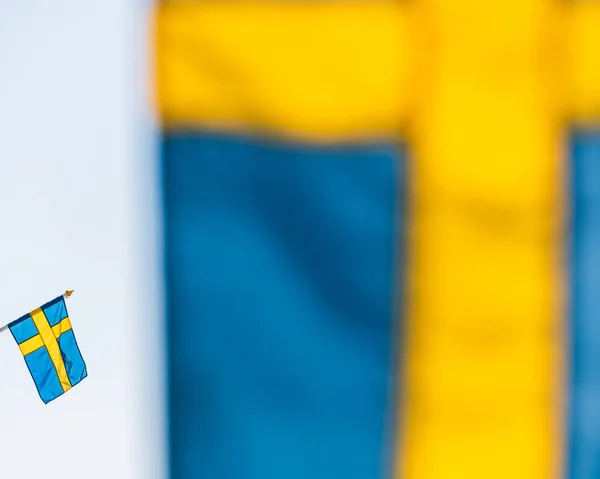 Swedish flag behind another flag